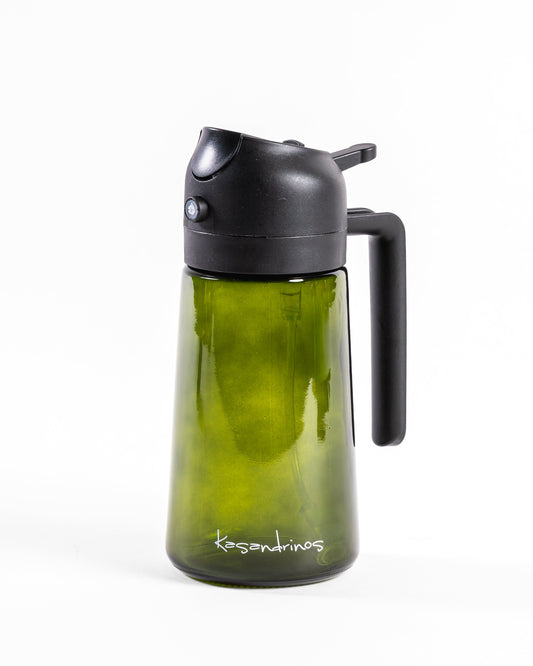 A green glass oil dispenser with a black plastic lid and handle, featuring the Kasandrinos brand name printed near the base, set against a plain white background.