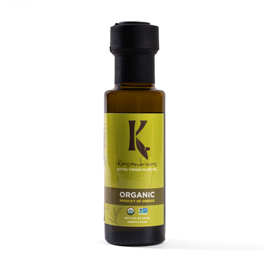 A bottle of Kasandrinos Organic Olive Oil. Product of Greece olive oil, featuring a black cap and a yellow-green label with a brown 'K' logo, set against a plain white background.